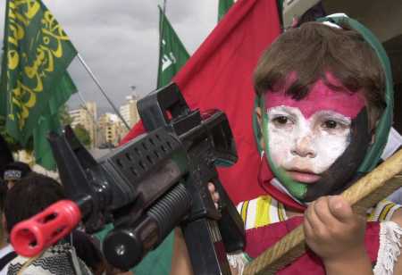 small Palestinian girl with toy rifle at anti-Israeli rally